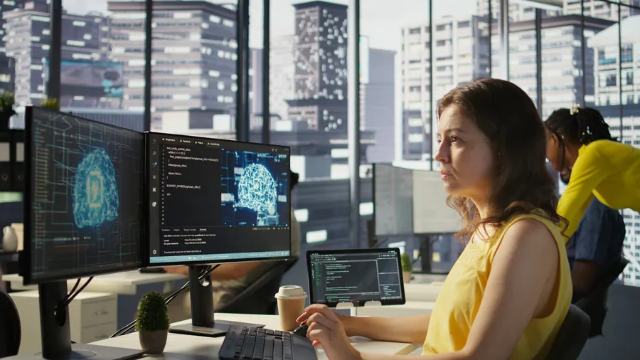 System administrator debugging AI software on a computer