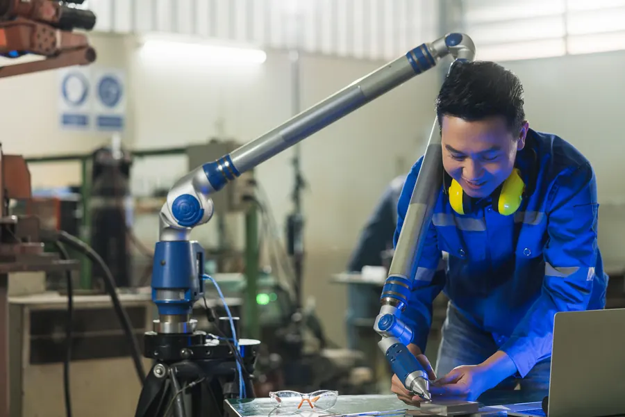 Engineer training on a CNC coordinate measuring machine