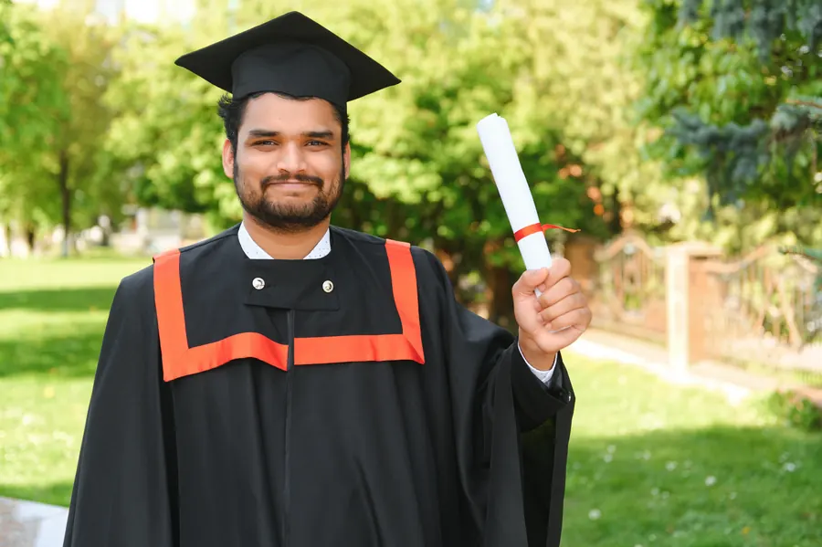 Graduate proudly holding a diploma