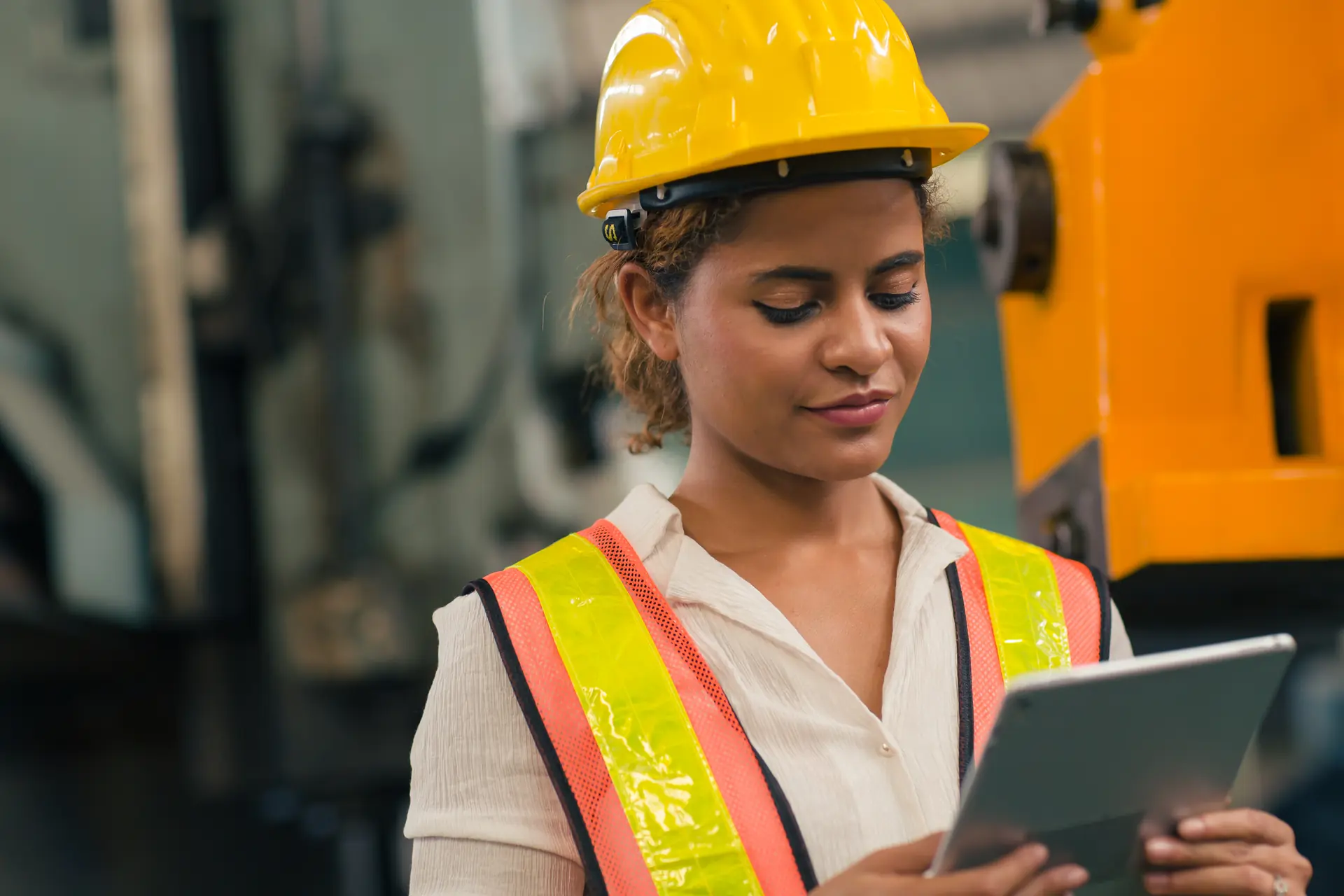 Industry supervisor managing operations digitally on a tablet