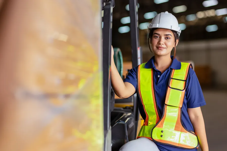 Woman engineer supervising a warehouse in safety gear